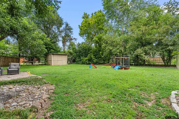 a view of a house with backyard and sitting area