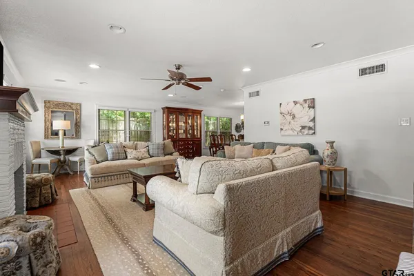 a living room with furniture a fireplace and a flat screen tv