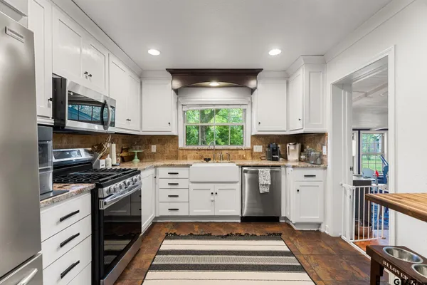 a kitchen with cabinets appliances and a counter space
