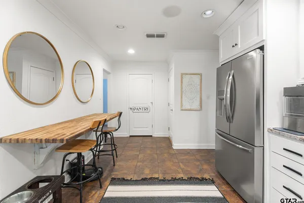 a dining room with furniture large windows and a fireplace