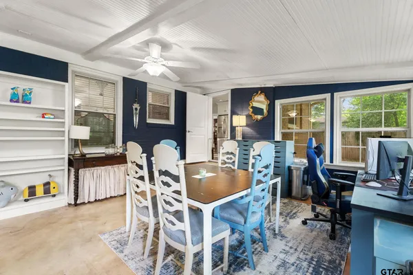 a living room with furniture and floor to ceiling windows