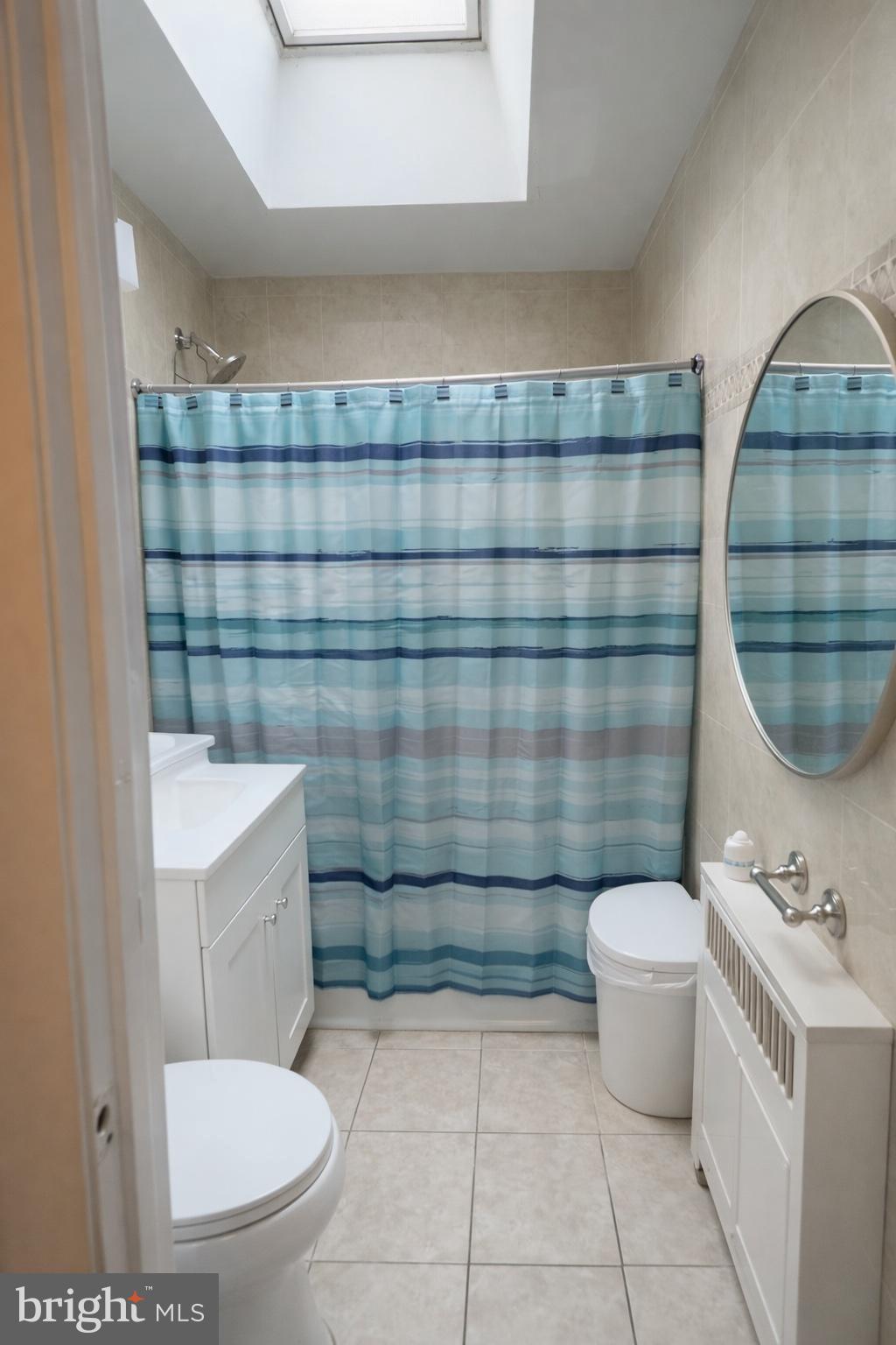 1305 Robbins Street Philadelphia, PA 19111 - Photo 12 of 19 a bathroom with a toilet a sink and a mirror