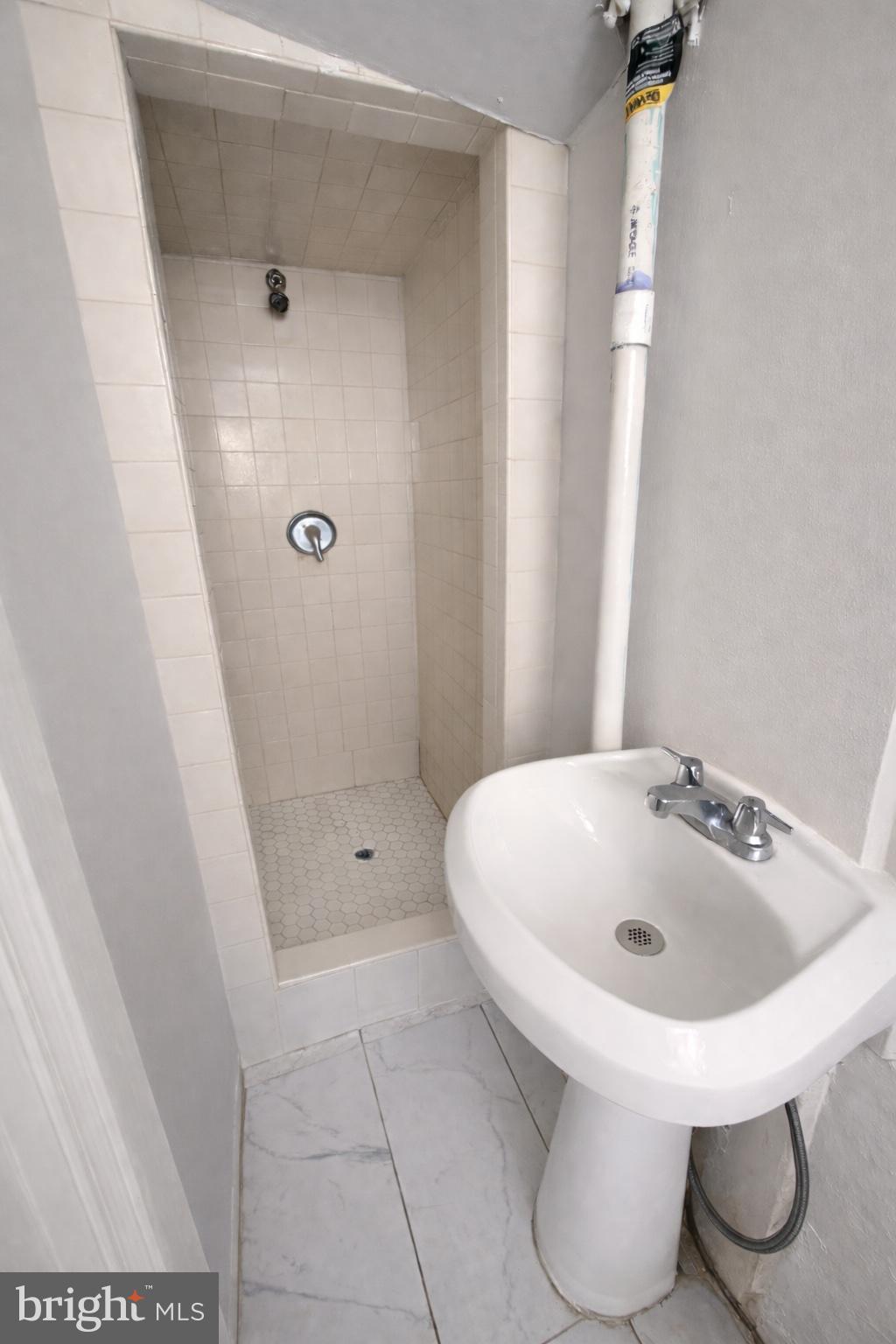 1305 Robbins Street Philadelphia, PA 19111 - Photo 17 of 19 a bathroom with a sink and mirror