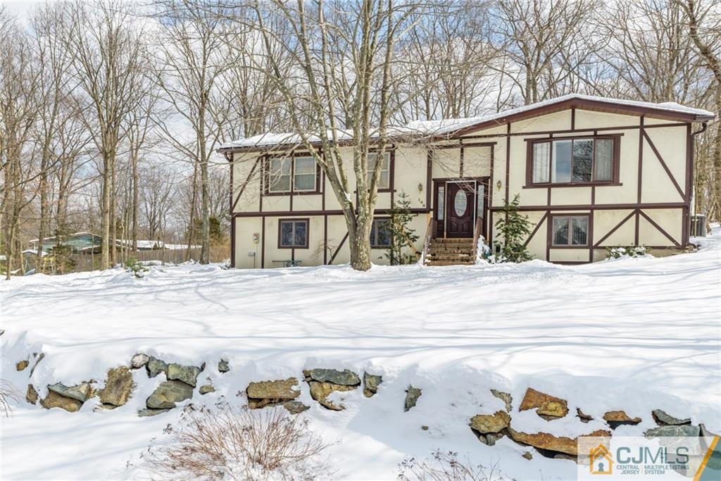 148 Rolling Ridge Road West Milford, NJ 07480 - Photo 1 of 25 a view of a house with snow on the road