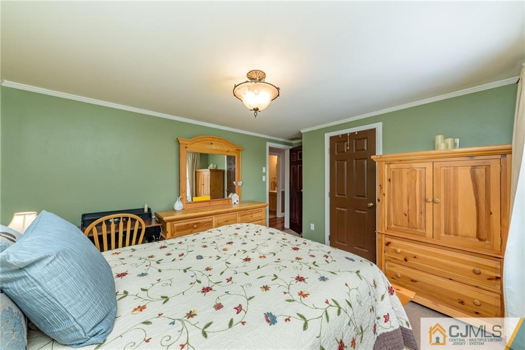 148 Rolling Ridge Road West Milford, NJ 07480 - Photo 14 of 25 a bedroom with a bed and dresser with mirror
