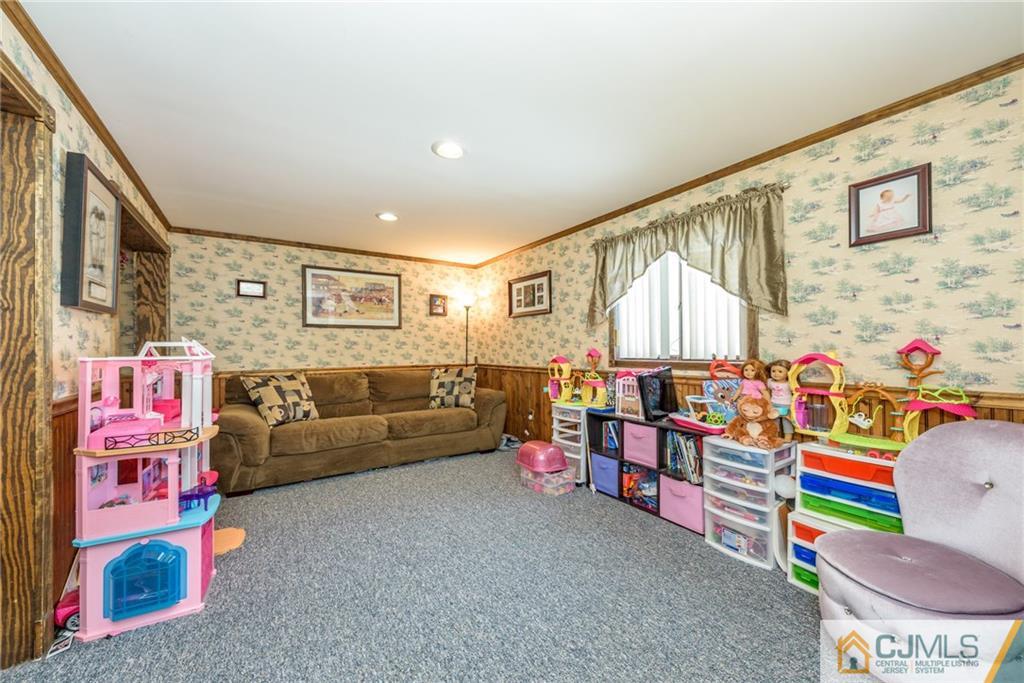 148 Rolling Ridge Road West Milford, NJ 07480 - Photo 20 of 25 a living room with furniture and a baby crib