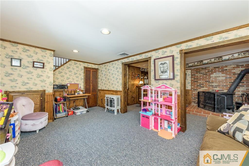 148 Rolling Ridge Road West Milford, NJ 07480 - Photo 21 of 25 a living room with furniture gym equipment and a fireplace