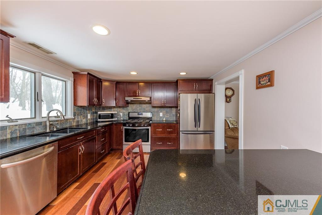 148 Rolling Ridge Road West Milford, NJ 07480 - Photo 7 of 25 a kitchen with stainless steel appliances a refrigerator stove and sink