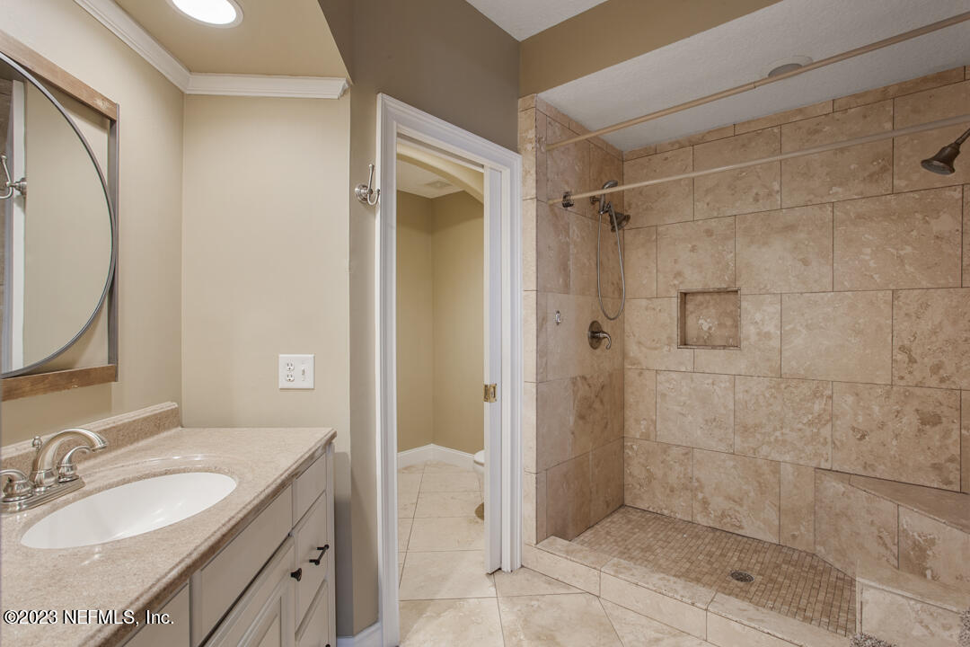 3165 Ravines Road, Unit 3604 Middleburg, FL 32068 - Photo 13 of 16 a bathroom with a granite countertop shower sink and mirror