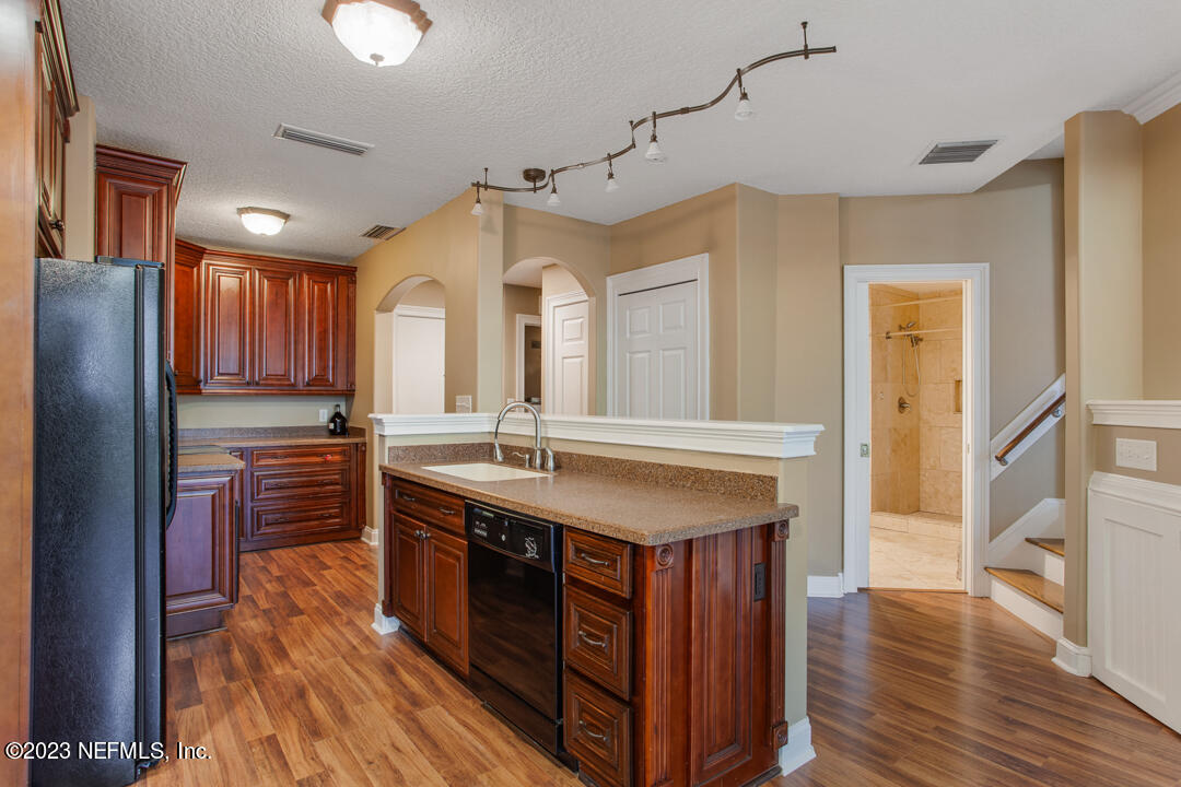 3165 Ravines Road, Unit 3604 Middleburg, FL 32068 - Photo 3 of 16 a kitchen with kitchen island granite countertop a sink appliances and cabinets