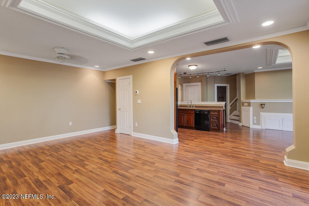 3165 Ravines Road, Unit 3604 Middleburg, FL 32068 - Photo 7 of 16 an empty room with wooden floor and windows