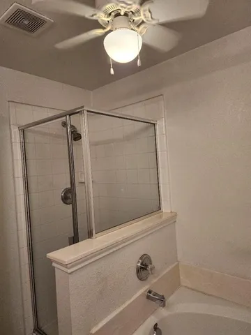 a bathroom with a shower and a sink