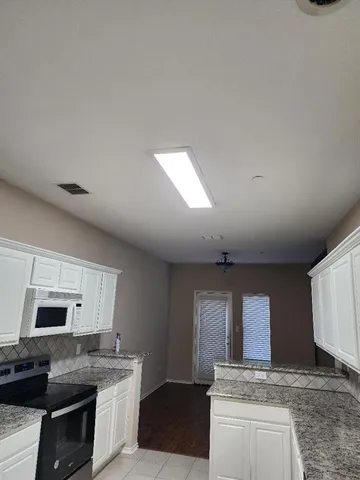 a kitchen with granite countertop a stove and a sink