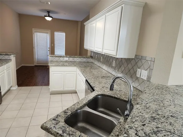 a kitchen with a sink and a stove top oven
