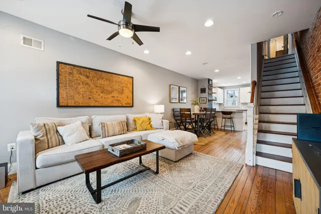 a living room with furniture and wooden floor