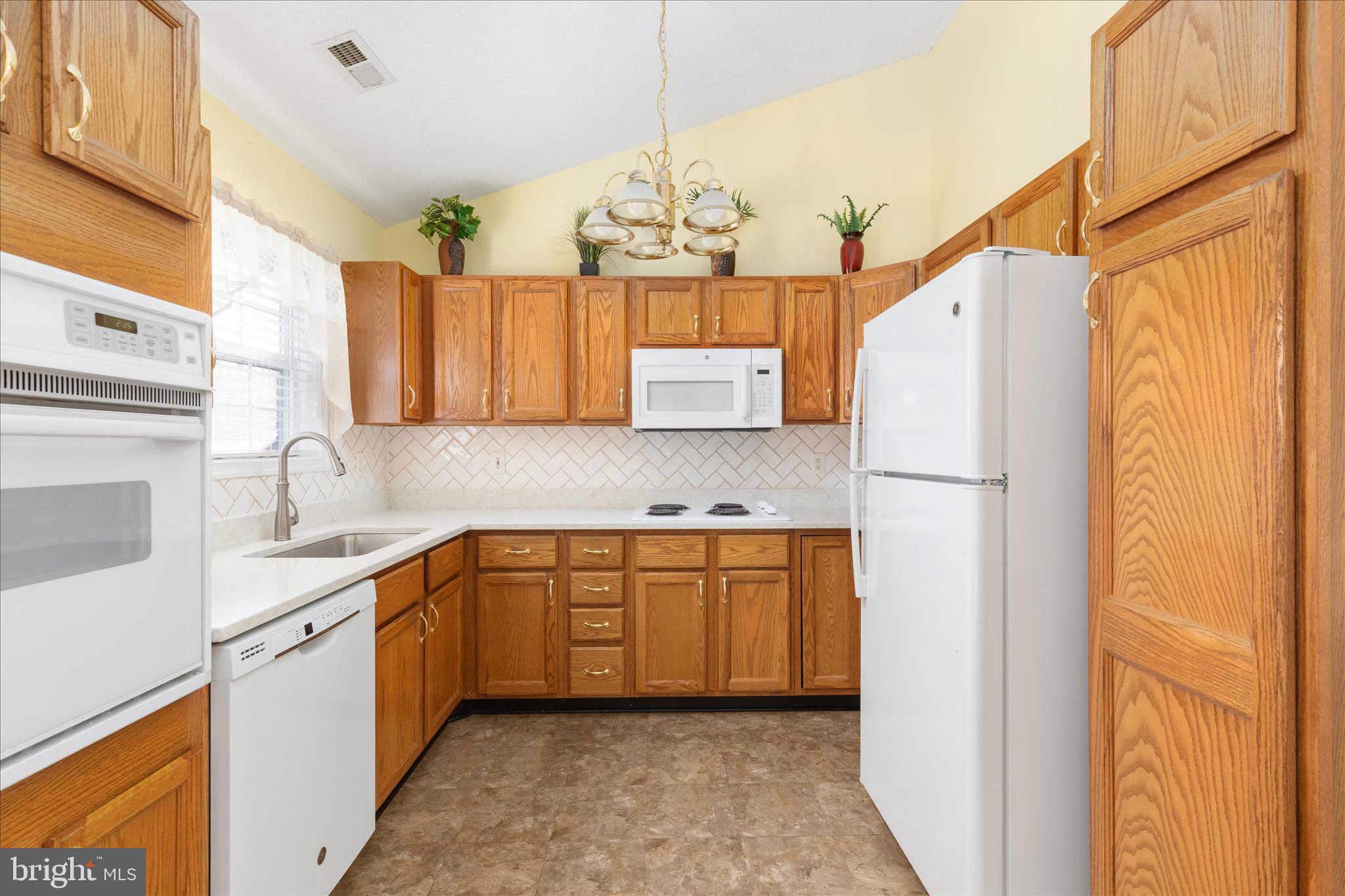 776 Ripplebrook Drive Culpeper, VA 22701 - Photo 10 of 30 a kitchen with a sink a refrigerator and cabinets