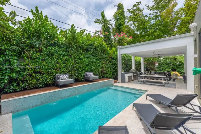 a view of a patio with table and chairs and potted plants