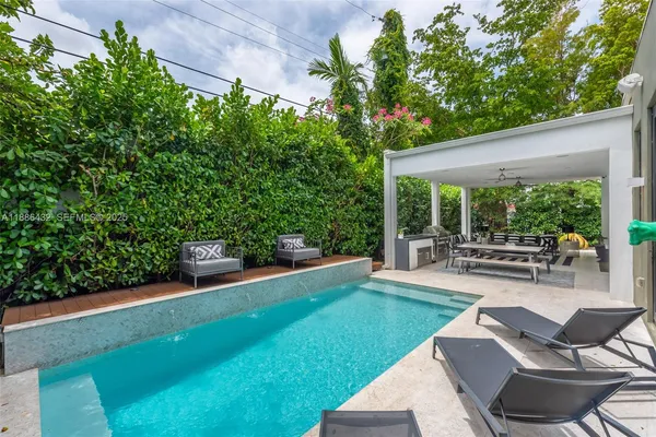 a view of a patio with table and chairs and potted plants