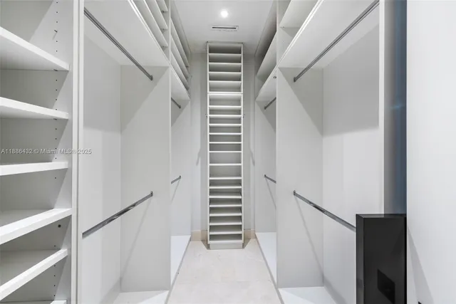 a view of staircase with white walls and a window