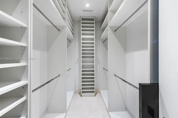 a view of staircase with white walls and a window