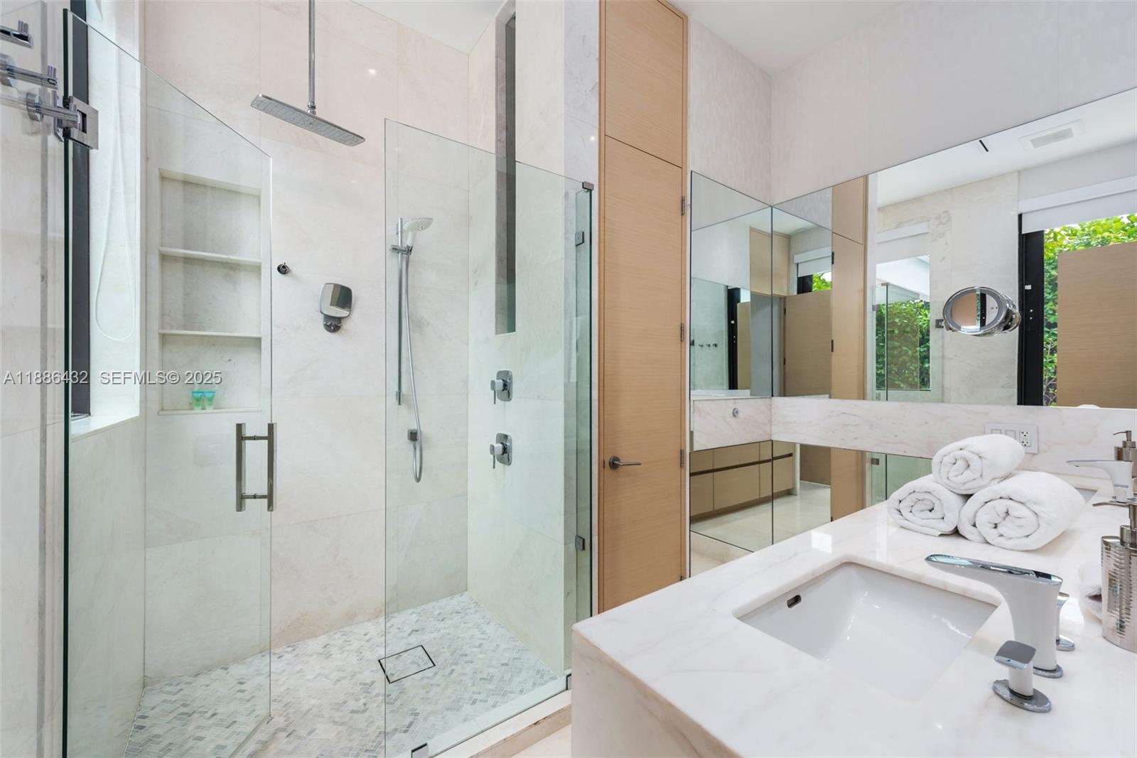 4675 Northeast 2nd Avenue Miami, FL 33137 - Photo 19 of 44 a bathroom with a sink vanity granite shower and a mirror