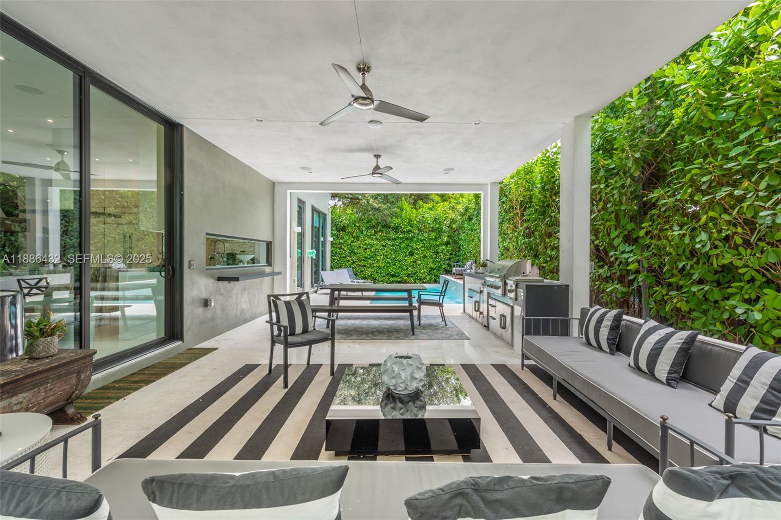 4675 Northeast 2nd Avenue Miami, FL 33137 - Photo 2 of 44 a living room with furniture and a large window