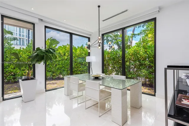 a room with patio furniture and a potted plant