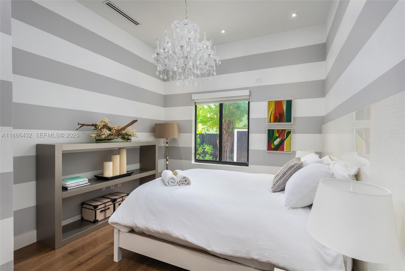 4675 Northeast 2nd Avenue Miami, FL 33137 - Photo 25 of 44 a bedroom with a bed and a chandelier