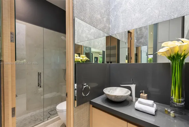 a bathroom with a toilet sink and shower