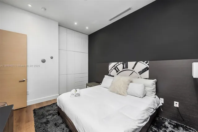 a bedroom with a bed and a night stand