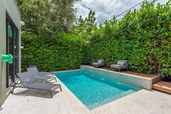 a view of a backyard with sitting area