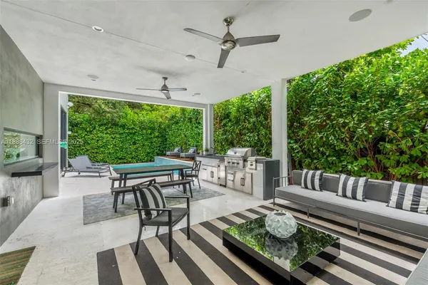 a outdoor space with chairs a couch and a potted plant
