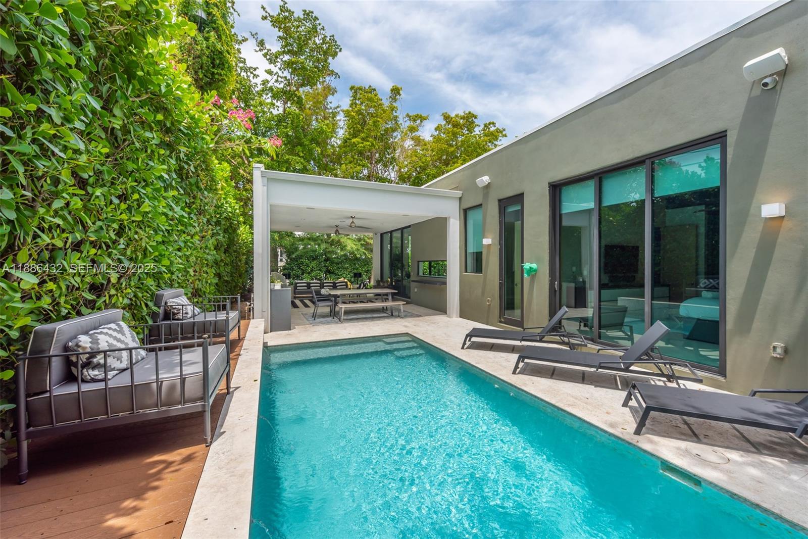 4675 Northeast 2nd Avenue Miami, FL 33137 - Photo 38 of 44 a view of a patio with a table chairs and garden