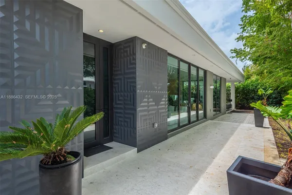 a lobby with a potted plant and outdoor space