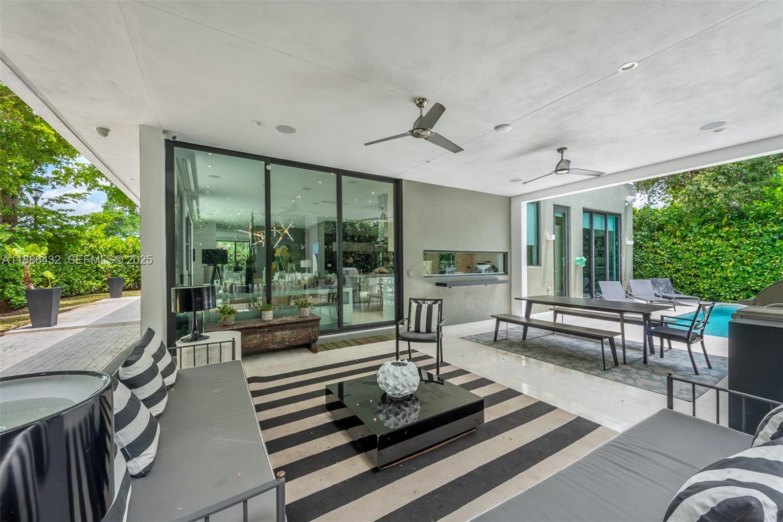 4675 Northeast 2nd Avenue Miami, FL 33137 - Photo 6 of 44 a living room with furniture and large windows