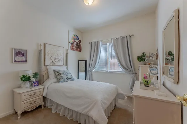 a bedroom with a bed and a large mirror