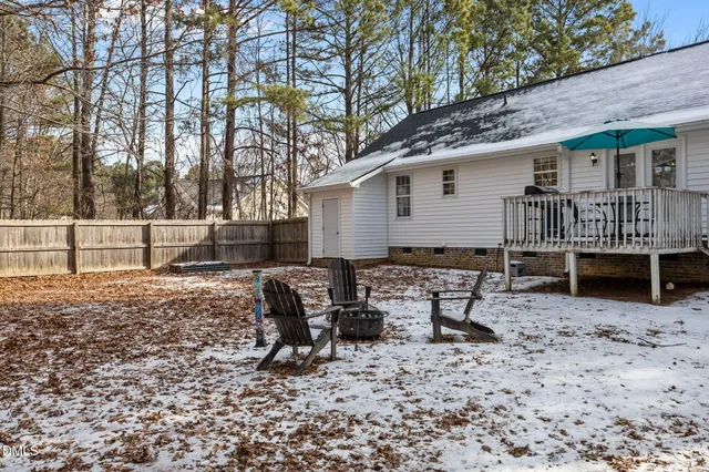 a backyard of a house with barbeque oven table and chairs