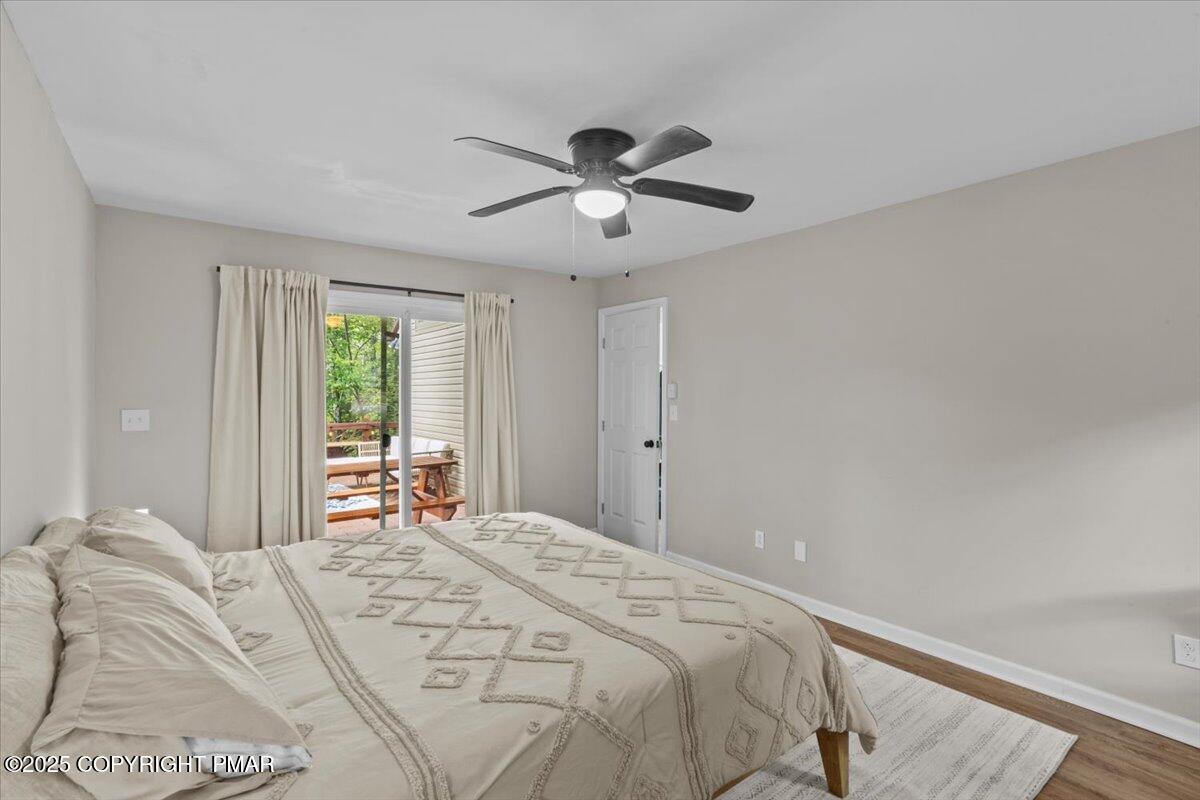 415 Canterbury Road Bushkill, PA 18324 - Photo 11 of 36 a bedroom with a large bed and a chandelier