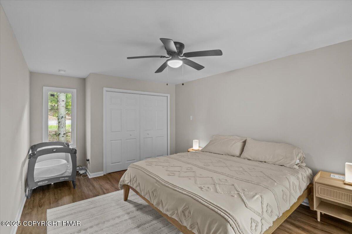 415 Canterbury Road Bushkill, PA 18324 - Photo 12 of 36 a bedroom with a bed and a chandelier