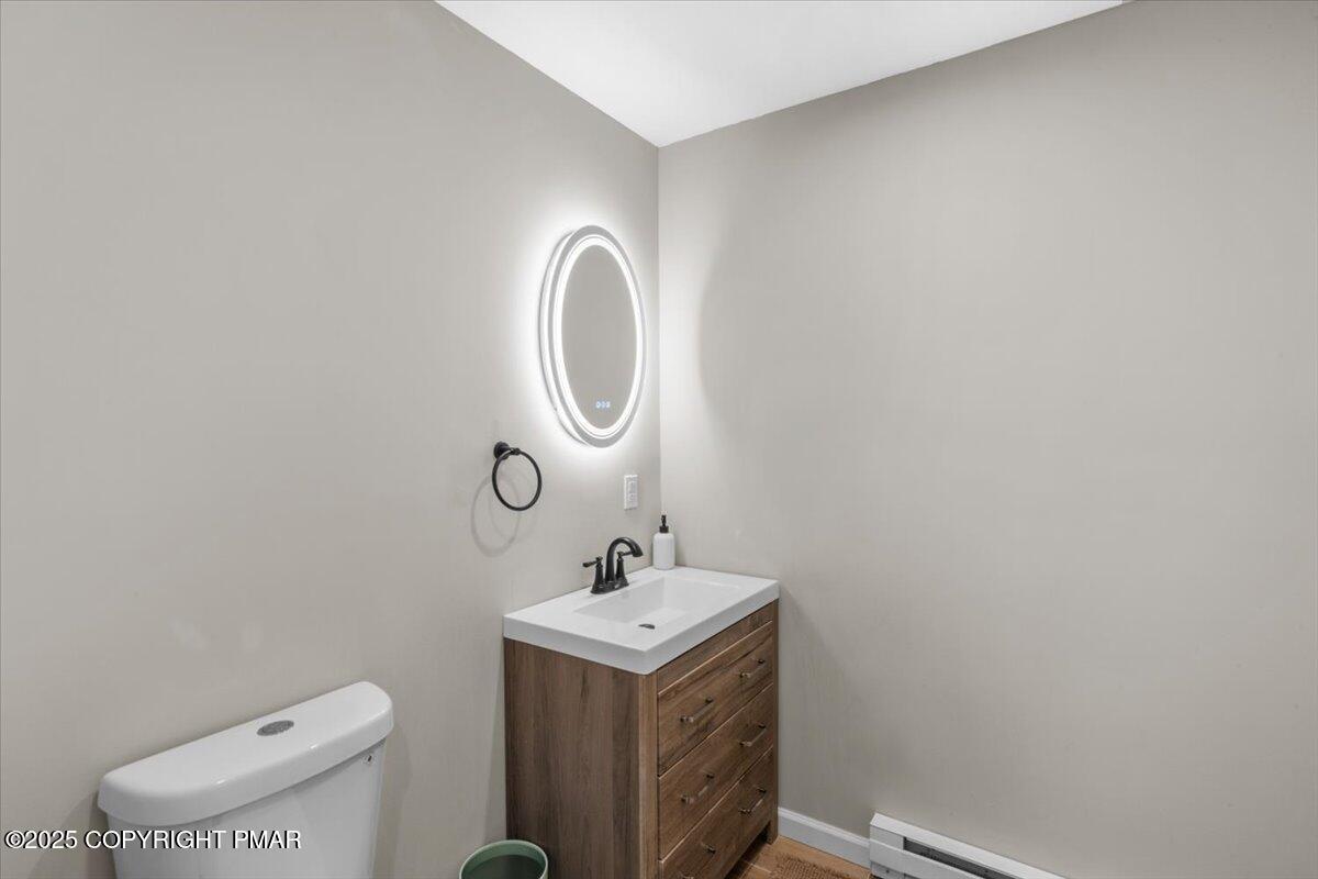 415 Canterbury Road Bushkill, PA 18324 - Photo 14 of 36 a bathroom with a sink a toilet and a mirror