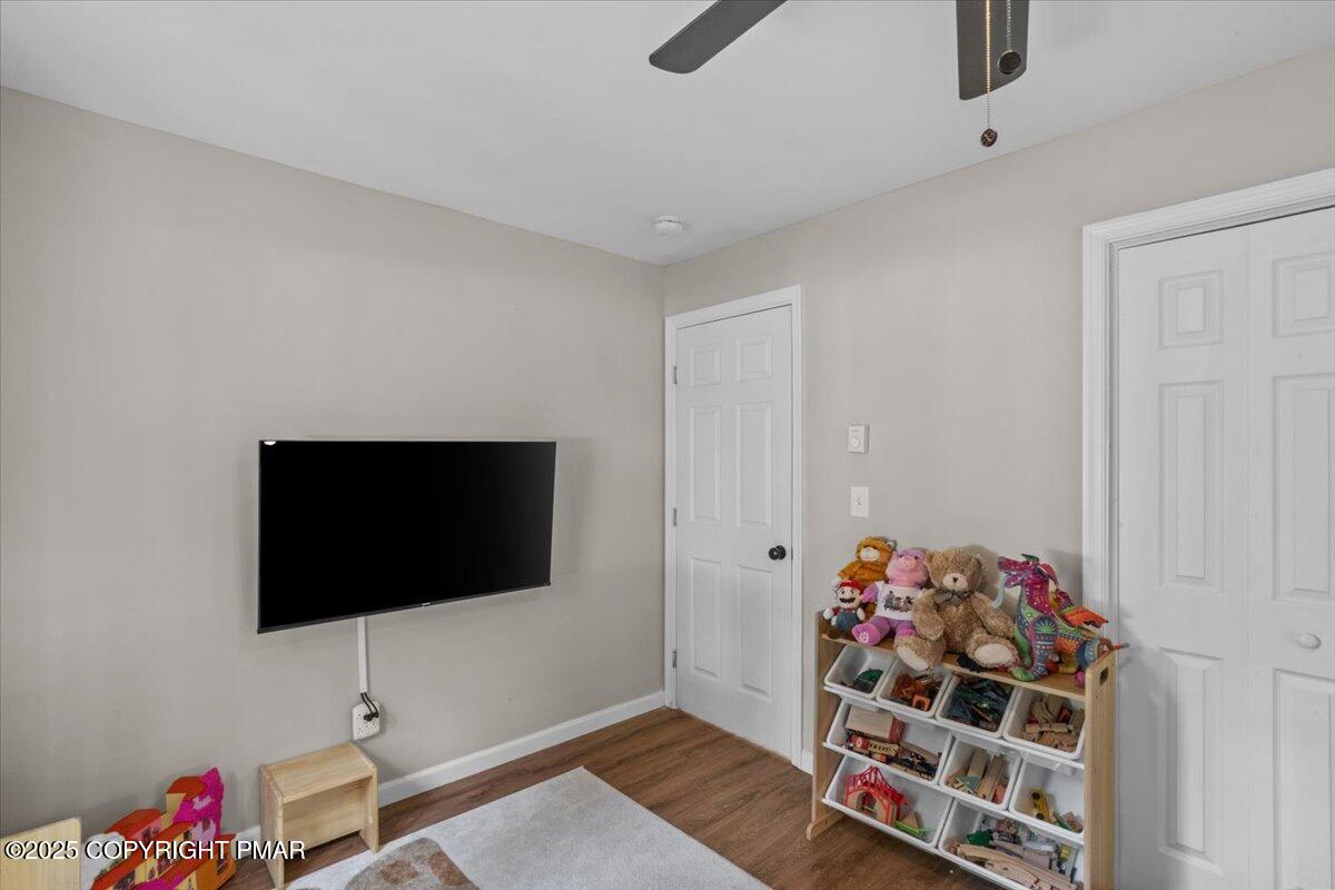 415 Canterbury Road Bushkill, PA 18324 - Photo 16 of 36 a living room with a flat screen tv and a couch