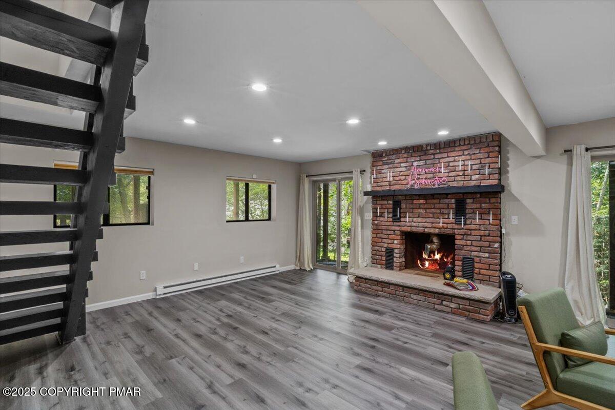 415 Canterbury Road Bushkill, PA 18324 - Photo 30 of 36 a view of an empty room with wooden floor fire place and a window
