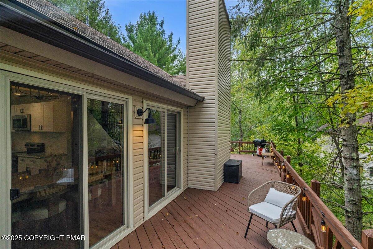 415 Canterbury Road Bushkill, PA 18324 - Photo 31 of 36 a view of a balcony with chairs and wooden fence