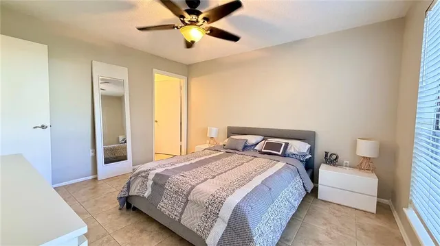 a bedroom with a bed and a large window