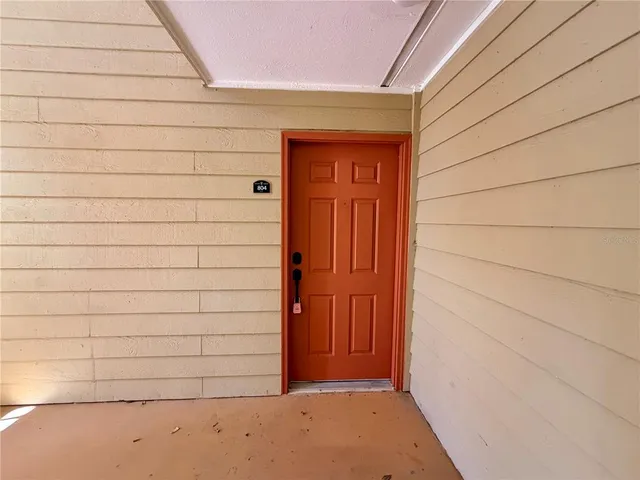 a kitchen with stainless steel appliances a refrigerator a stove a sink dishwasher with a dining table and chairs