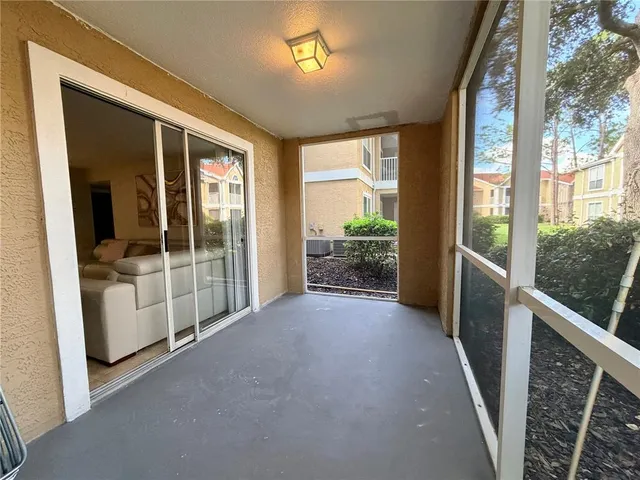 a kitchen with a refrigerator a stove top oven and white cabinets