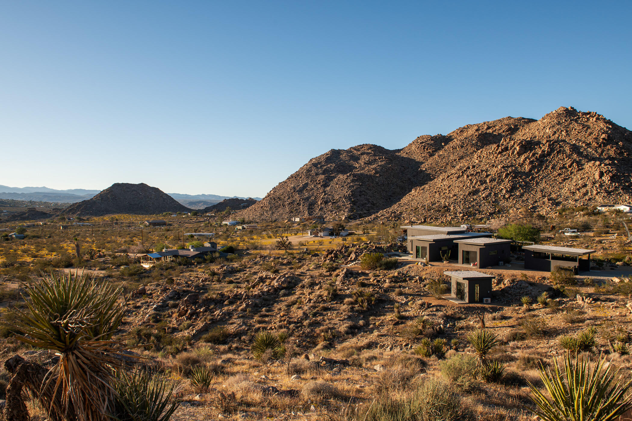 8520 Purple Sage Road Joshua Tree, CA 92252 - Photo 34 of 36 a view of a large building with a mountain in the background