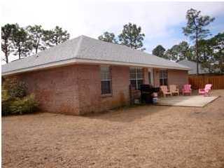 151 Buck Road Santa Rosa Beach, FL 32459 - Photo 3 of 16 a view of a house with backyard and sitting area