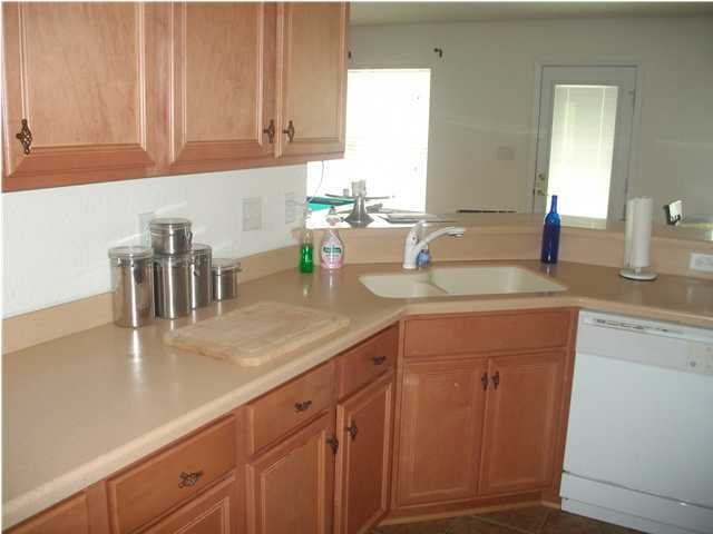 151 Buck Road Santa Rosa Beach, FL 32459 - Photo 5 of 16 a kitchen with granite countertop a sink a stove and cabinets