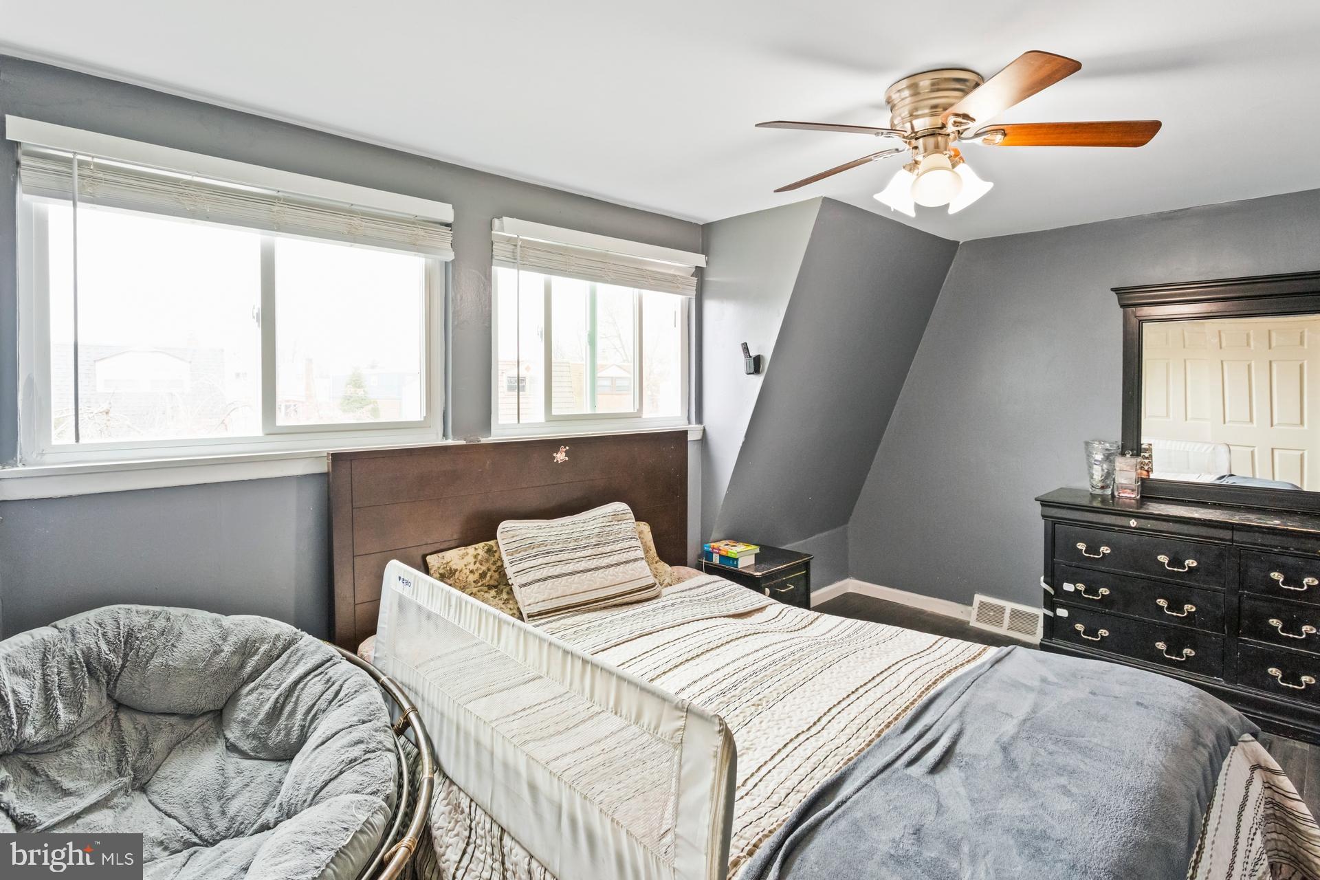 1043 Foster Street Philadelphia, PA 19116 - Photo 16 of 22 a bedroom with a bed and a chandelier